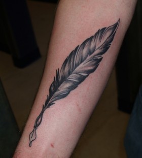 Feather pen arm tattoo
