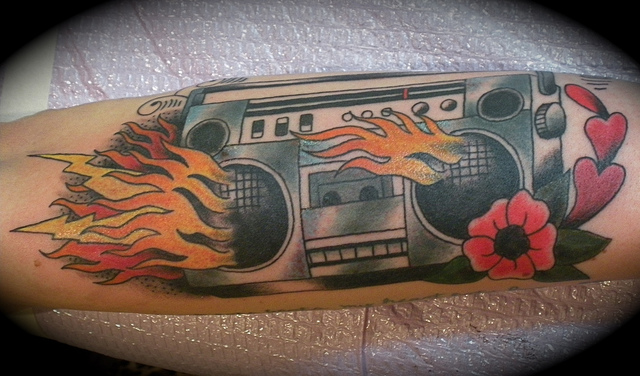 Flaming boombox and flower tattoo