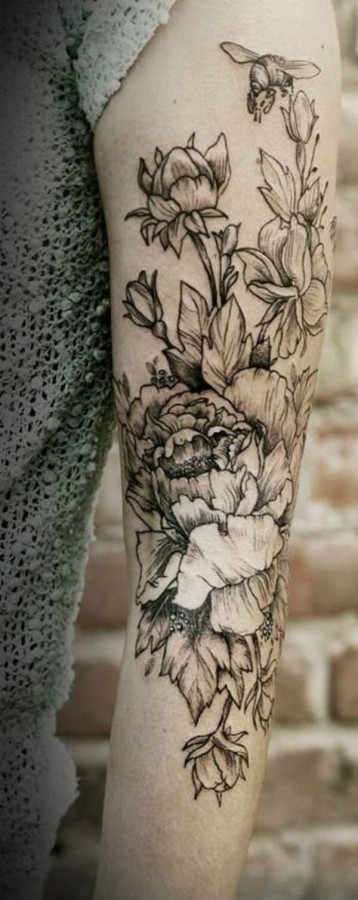 Flowers and bees arm tattoo