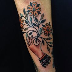 Flowers in hand tattoo by Matt Cooley