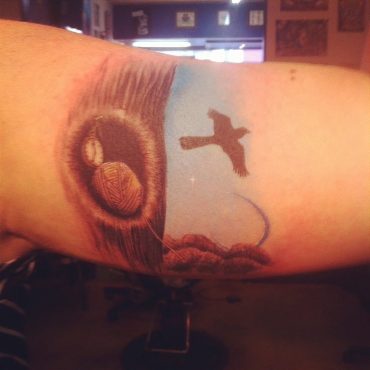 Flying mockingbird arm tattoo