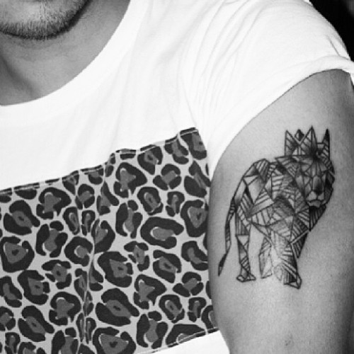 Geometrical lion arm tattoo