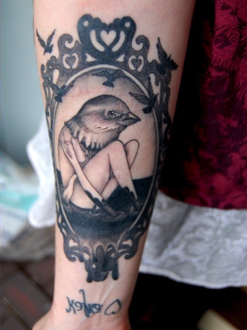 Girl with a birds head frame tattoo