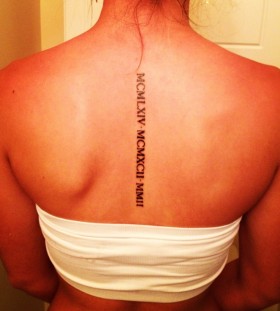 Girl's back Roman number's tattoo