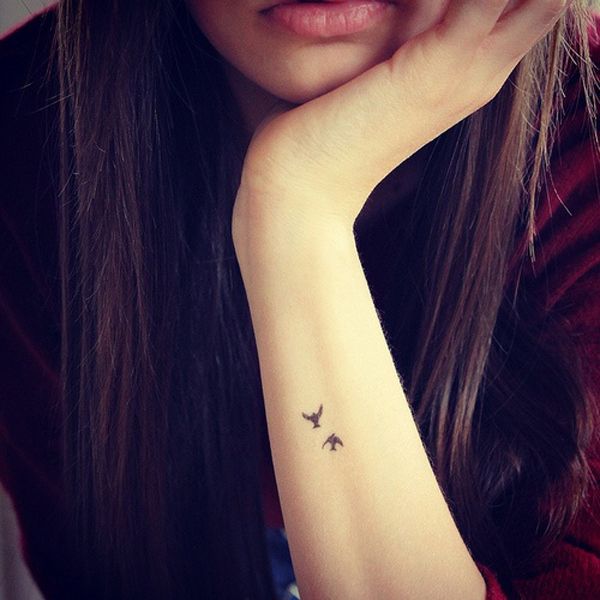Girl’s cute lips and tiny tattoo