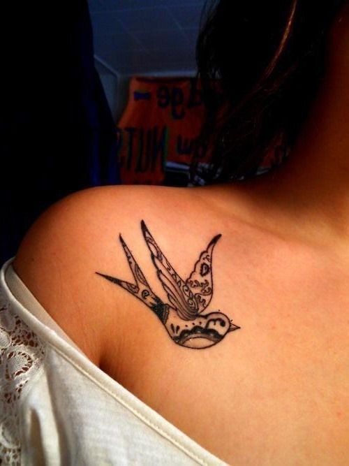 Girl’s shoulder black tribal bird tattoo