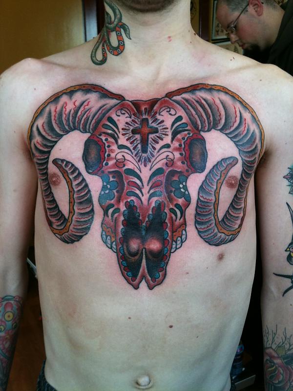 Goat skull chest tattoo
