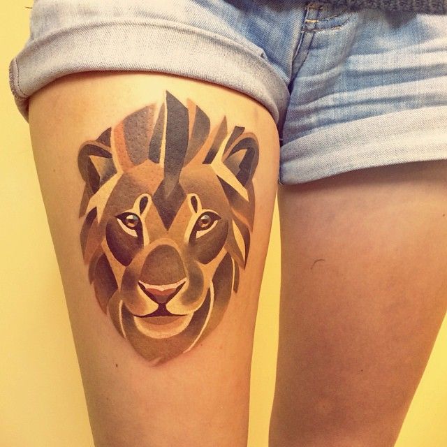 Golden geometric lion leg tattoo