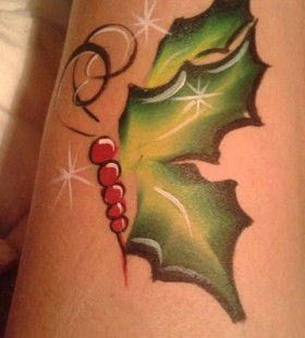 Green leafs christmas tattoo