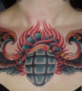 Grenade with wings chest tattoo