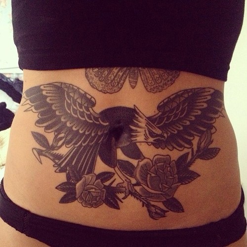 Hawk and flowers stomach tattoo