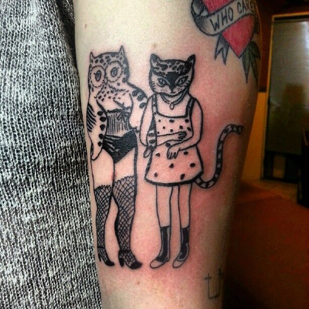 Human owl and cat tattoo
