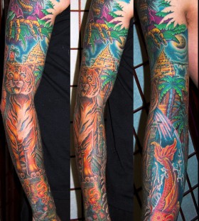 Jungle theme arm tattoo