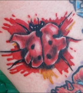 Bloody ladybug arm tattoo