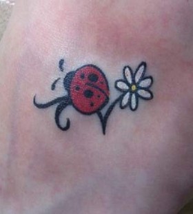 Ladybug and flower tattoo