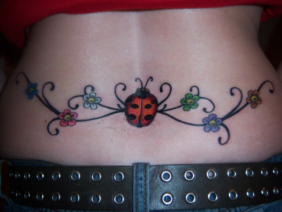 Ladybug and flowers back tattoo
