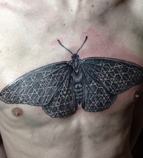 Large moth chest tattoo
