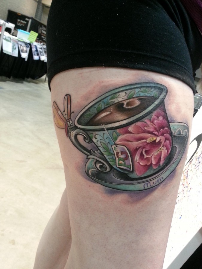 Large teacup leg tattoo