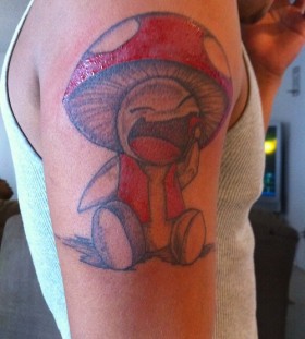 Laughing mushroom arm tattoo