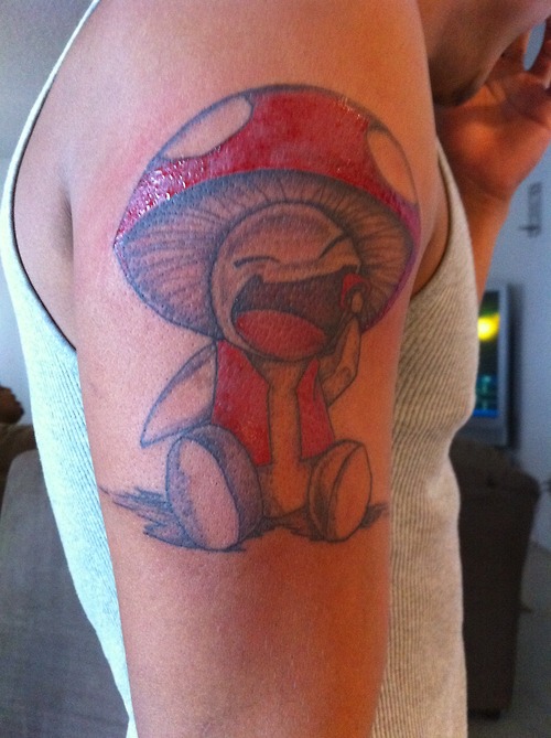 Laughing mushroom arm tattoo
