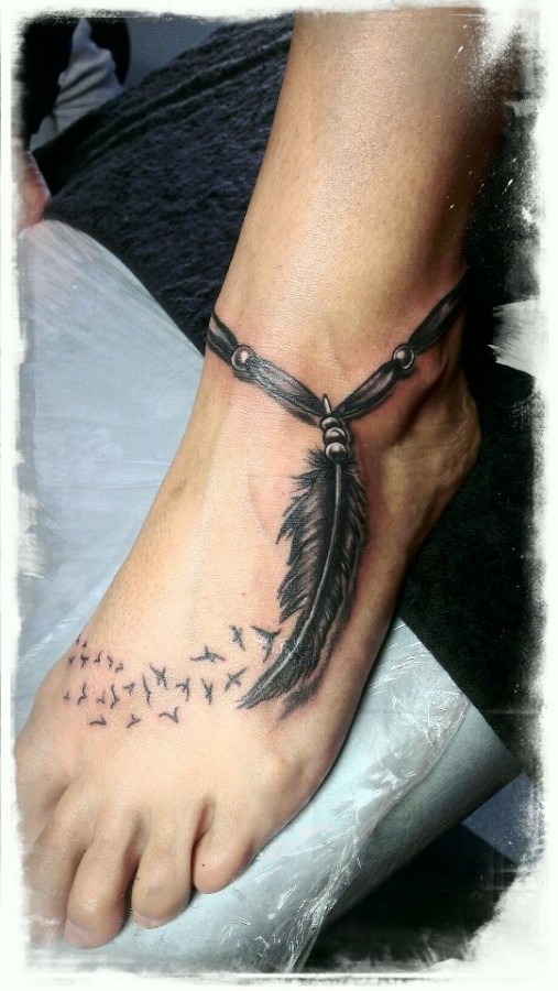 Leg’s feather and tribal bird tattoo