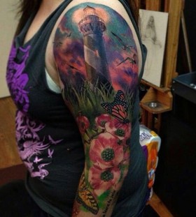 Lighthouse and flowers full arm tattoo