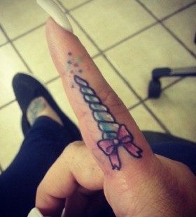Long nail and unicorn tattoo on finger