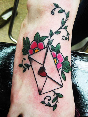 Lovely envelope and flowers foot tattoo