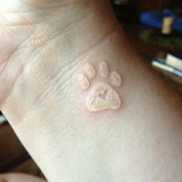 Lovely looking dog’s palm tattoo