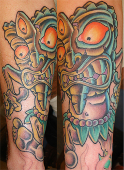 Man with tiki mask tattoo
