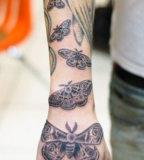 Many moths arm tattoo