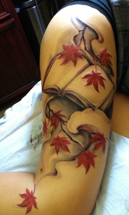 Maple leaves and book tattoo