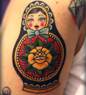 Matryoshka with yellow flower tattoo