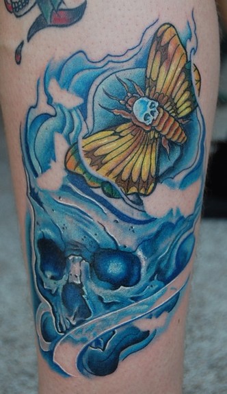Moth and blue skull tattoo