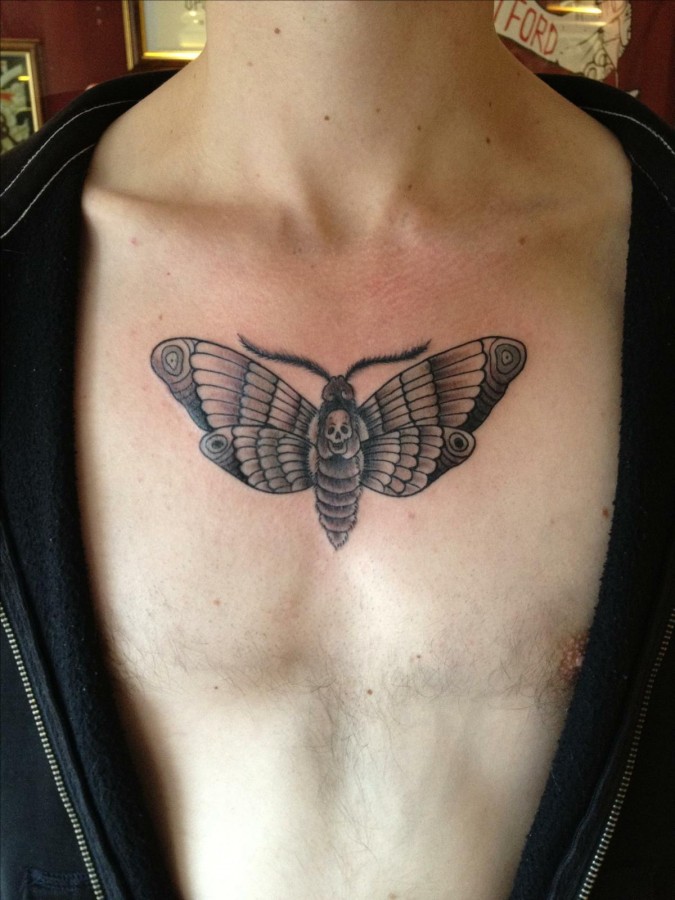 Moth with skull chest tattoo