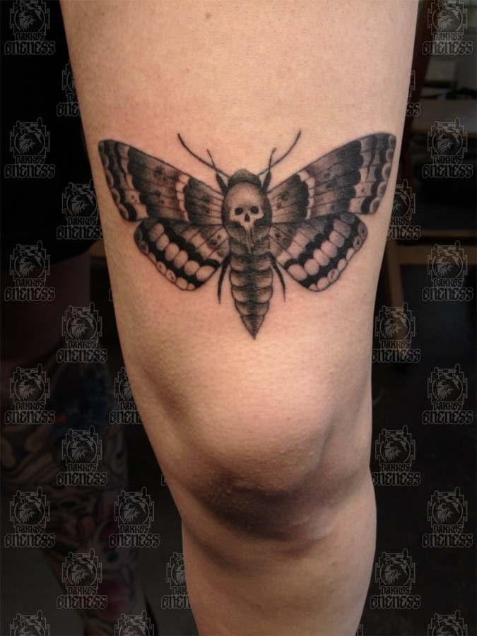 Moth with skull leg tattoo