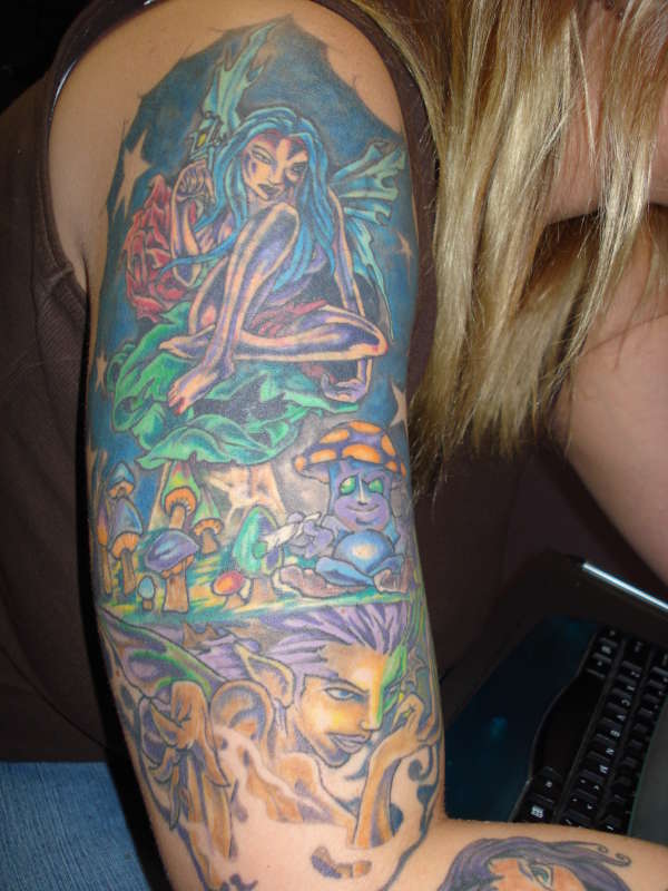 Mushrooms and fairies arm tattoo