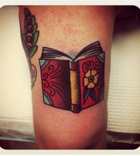 Nice book tattoo by Charley Gerardin