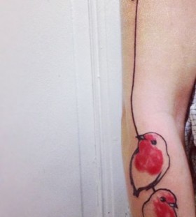 Nice red birds arm tattoo