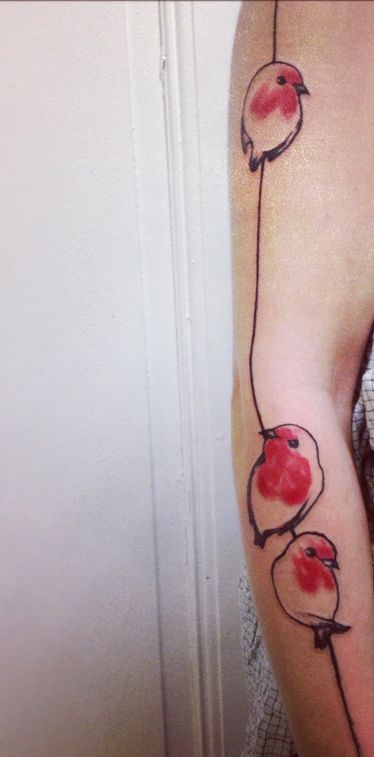 Nice red birds arm tattoo