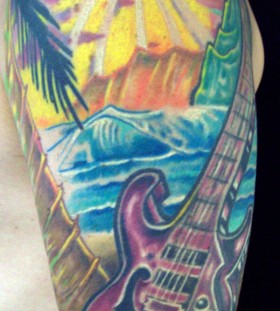 Ocean and guitar tattoo