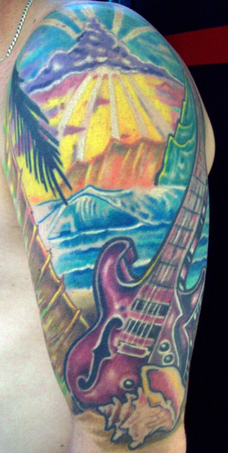 Ocean and guitar tattoo