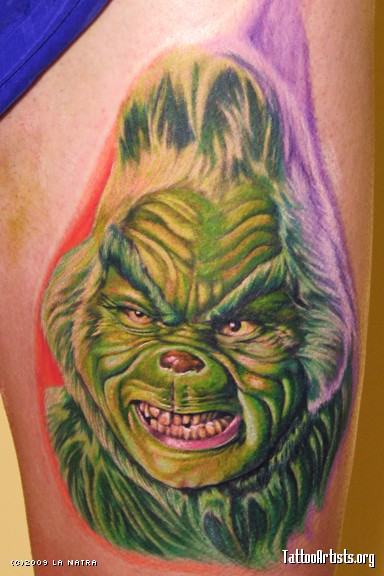 Old and angry looking grinch christmas tattoo