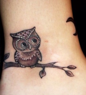 Owl on a branch tattoo