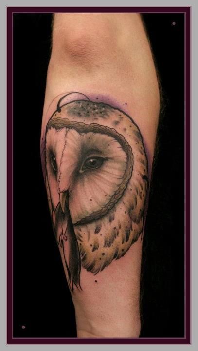 Owl with a mouse tattoo