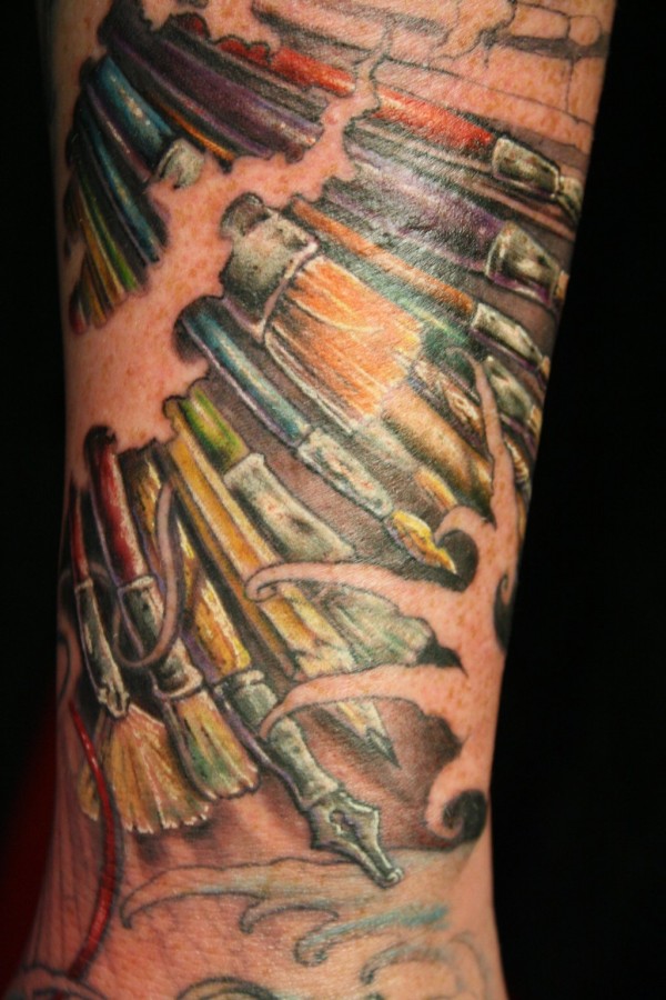 Paint brushes arm tattoo