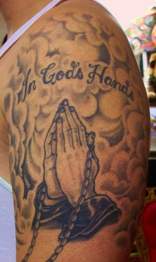 Praying hands and clouds tattoo