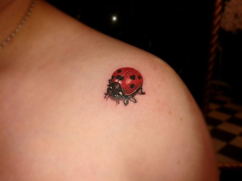 Realistic ladybug shoulder tattoo