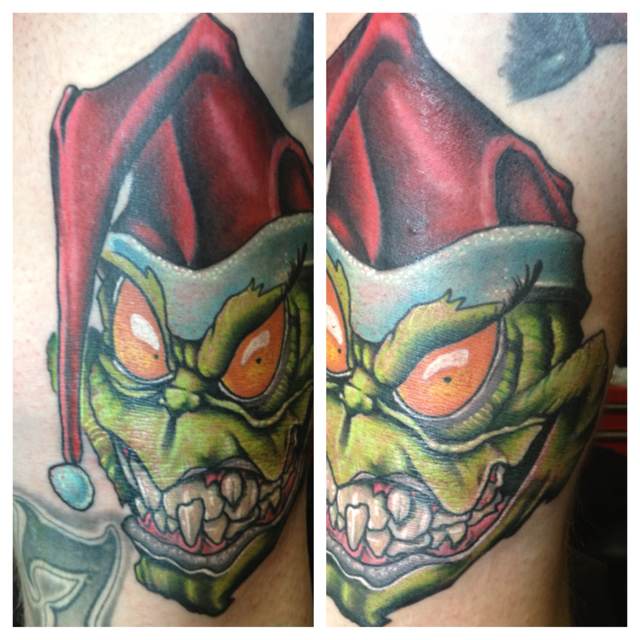 Red cap and green grinch christmas tattoo