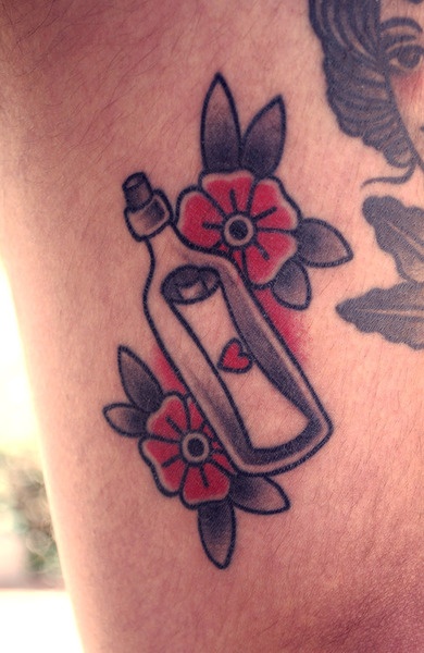 Red flowers and bottle tattoo